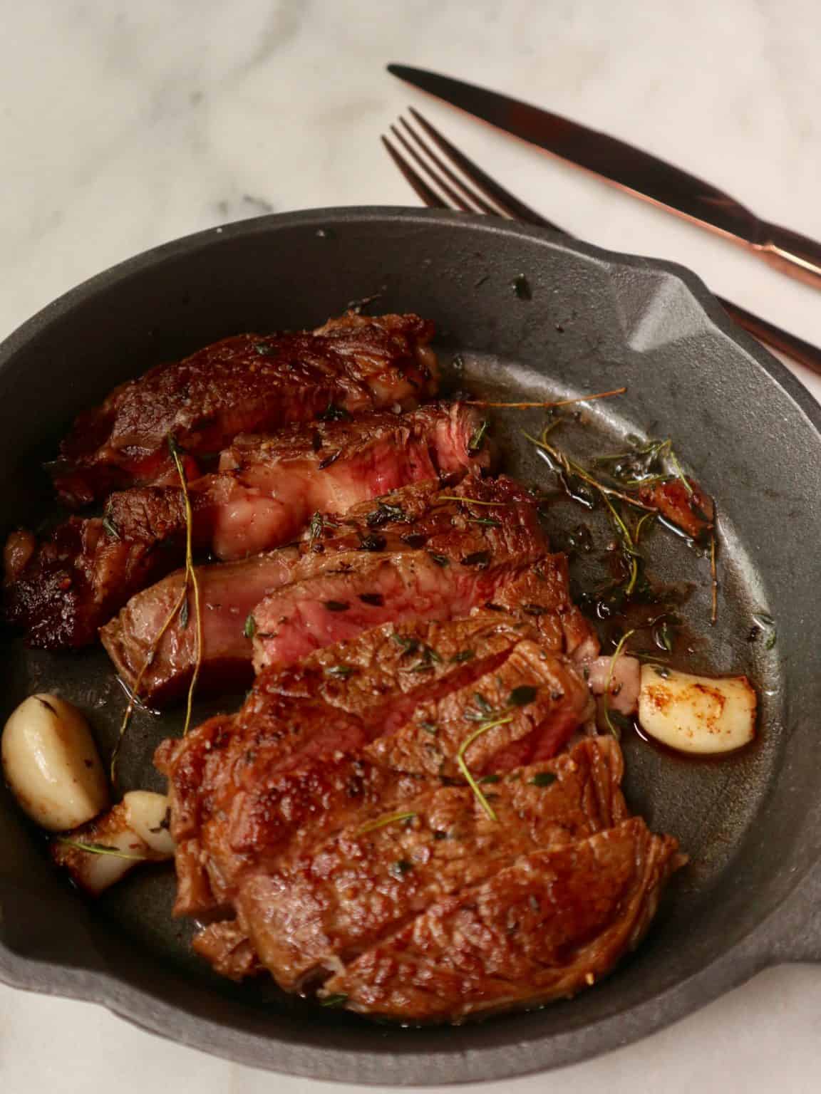Rib Eye steak with butter, thyme and garlic Image
